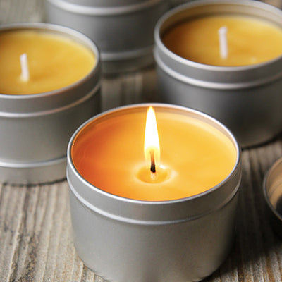 a group of beewax candles with a flame