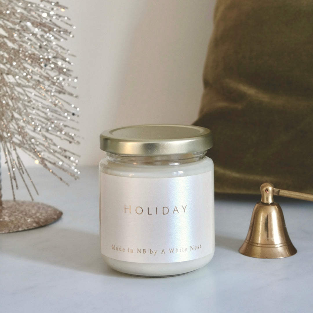 a Holiday Soy Wax Candle from A White Nest on a table