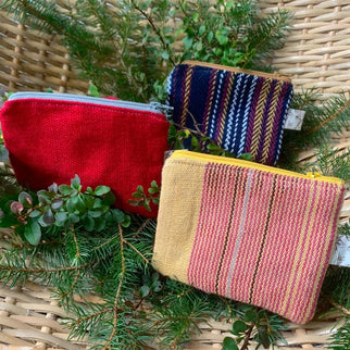a group of colorful Portable Pockets from Andrea Butler Designs on a basket