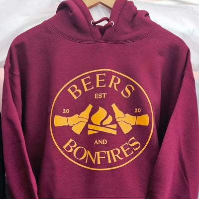 Maroon hoodie with yellow 'Beers and Bonfires' text and graphics on a white background
