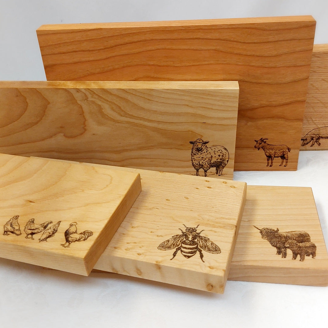a group of cheese boards from Brent Rourke with images of animals on them