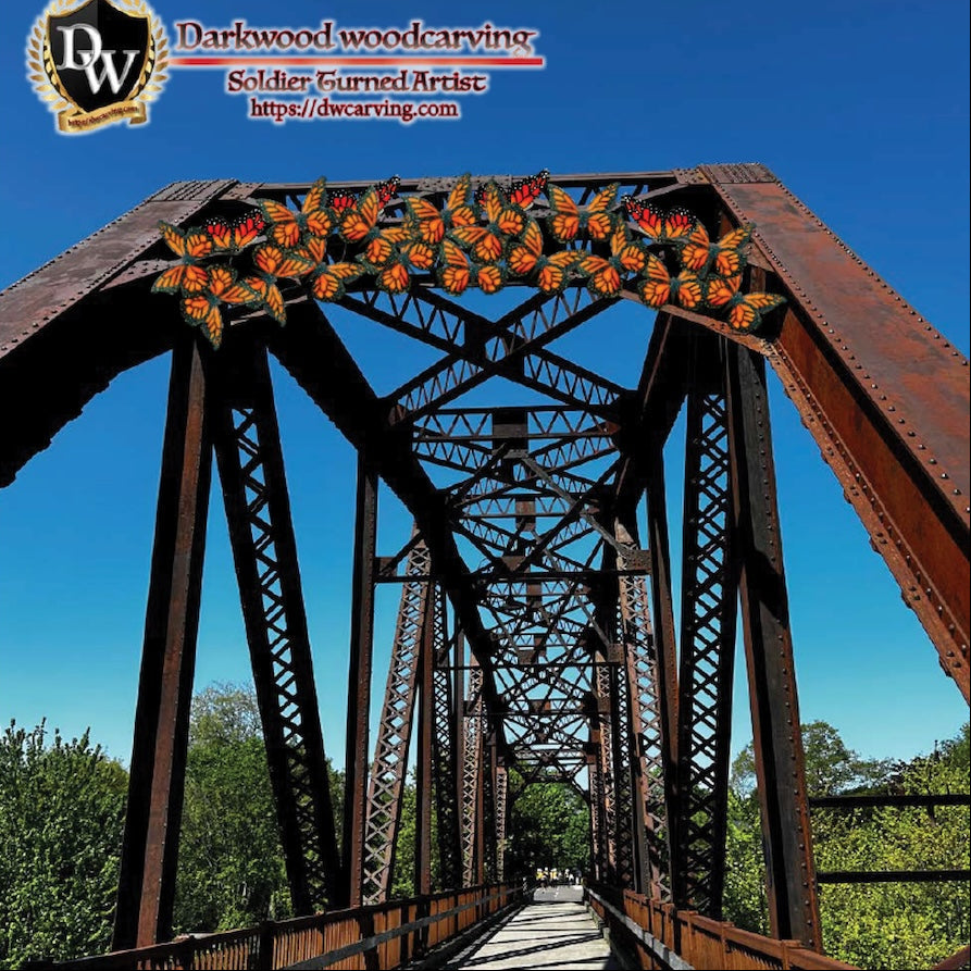 Rust-colored metal bridge with decorative elements against a clear blue sky, featuring the 'Darkwood Woodcarving' logo.